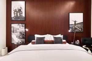 a bedroom with a large bed with wooden walls at The F1 Scene Designer Apartment With120 Inch in Yas Island