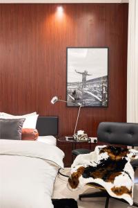 a bedroom with a bed and a desk with a cow blanket at The F1 Scene Designer Apartment With120 Inch in Yas Island