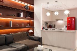 a living room with a couch and a kitchen at The F1 Scene Designer Apartment With120 Inch in Yas Island +42 photos