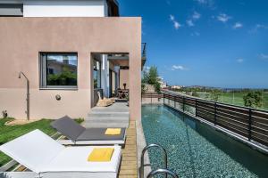an image of a house with a swimming pool at Happy Villa in Galatás