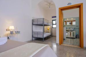 a bedroom with a bunk bed and a bathroom at Marealto Panorama in Porto Cesareo