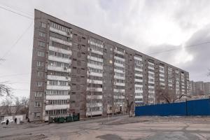 a large apartment building on a city street at Просторная квартира рядом с набережной in Pavlodar