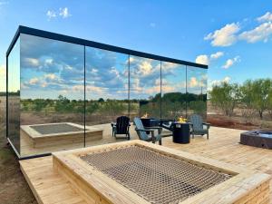 a patio with a table and chairs on a deck at Perseus at The Retreat in Fredericksburg
