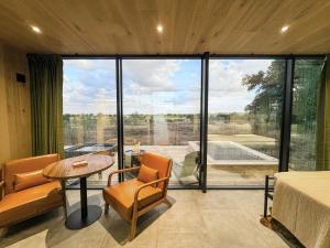 a room with a large glass door with a table and chairs at Perseus at The Retreat in Fredericksburg