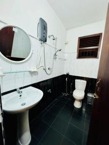 a bathroom with a sink and a toilet and a mirror at Villa Happy Nest in Unawatuna +41 photos