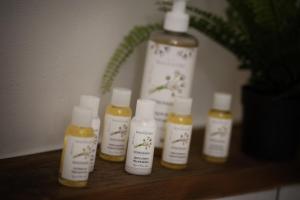 a group of four bottles of moisturizers on a shelf at U Šuterů Boutique Hotel in Prague