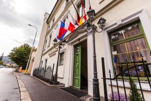 a building with flags on the side of a street at Spa Hotel Panorama in Karlovy Vary