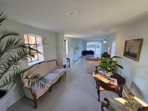 a living room with a couch and a table at Solvang in Assens