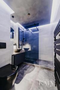 a bathroom with two sinks and two mirrors at Apartman KATY in Vukovar +21 photos