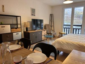 a bedroom with a bed and a table with chairs at Studio coin montagne au pied des pistes - 4 couchages - Risoul 1850 - FR-1-330-88 in Risoul