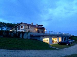 a house sitting on top of a hill at night at Apartamentos Villa Sofía in San Vicente de la Barquera