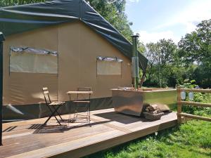 a tent with a table and chairs on a deck at The Apple Bobber - Ukc7130 in Cratfield +2 photos