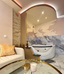 a living room with a tub and a glass table at Apartman Flamingos in Rača +14 photos