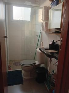 a bathroom with a toilet and a shower and a sink at Bem praiana in Praia Grande +13 photos