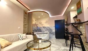 a living room with a white couch and a glass table at Apartman Flamingos in Rača