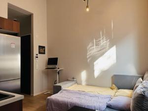 a living room with a couch and a laptop on a wall at Double Sofa Bed in a Stunningly Tall Shared Studio in Helsinki