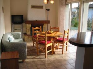 un salon avec une table et des chaises et une cheminée dans l'établissement Les Buis, à Dieupentale