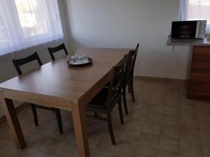 a wooden table and chairs in a kitchen at Vándor Szálló in Kecskemét