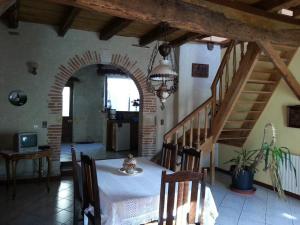 une salle à manger avec une table et un escalier dans l'établissement Gîte près de l'auberge, à Saint-Antoine