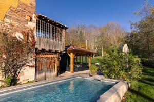a swimming pool in the yard of a house at Le moulin de Varax in Saint-Paul-de-Varax