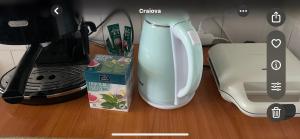 a white blender sitting on a counter next to a box at Apartament Eric in Craiova