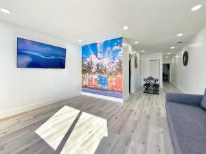 a living room with a couch and a painting on the wall at Lux Miami Escape - Near Brickell- Free Parking in Miami