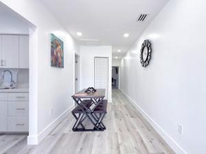 a kitchen with a table in the middle of a hallway at Lux Miami Escape - Near Brickell- Free Parking in Miami +18 photos