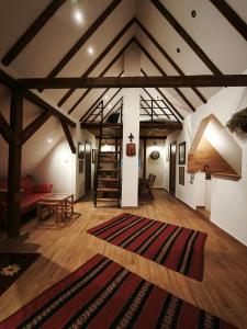 a living room with a large rug on the floor at Kućica Osmeha in Donja Ralja