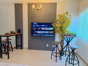 a living room with two bar stools and a tv at Unwind with Peace at Cheer Residences SM Marilao-Philippine Arena in Marilao