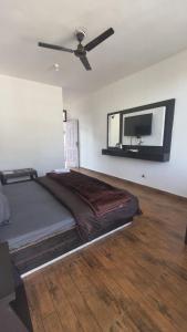 a bedroom with a large bed and a flat screen tv at Mcleodganj diaries Guesthouse in Dharamshala +19 photos