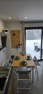 a kitchen with a table with glasses on top of it at L'Aiguillon - Studio avec Jacuzzi pour 2 personnes et enfants proche stations - Idéal couple avec 1 enfant in Saint-Jean-de-Sixt +23 photos