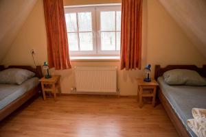ein Schlafzimmer im Dachgeschoss mit zwei Betten und einem Fenster in der Unterkunft Ferienhaus für 6 Personen ca 66 m in Kuldiga, Kurland in Kuldīga