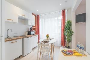 a kitchen with a small table and a counter top at Kazkle Etablissement in Boulogne-sur-Mer +17 photos