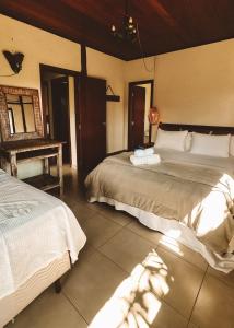 a bedroom with two beds and a piano at Vale do Elefante - Casa com Jacuzzi e Cachoeira in Santana do Riacho