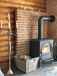 a fireplace in a room with a brick wall at villa kunterBUNT in Grödersby