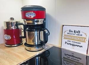 a red coffee maker sitting on top of a shelf at villa kunterBUNT in Grödersby