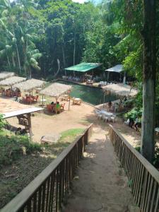 a view of a beach with tables and umbrellas at Hostel Casa Grande de Outeiro in Belém