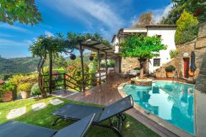 a backyard with a swimming pool and a house at Aenaon Villa with Private Pool Panoramic view in Mileai