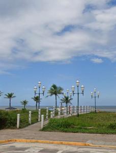 グァラトゥバにあるFlamingo Pé na areia - Centro/Guaratubaのビーチの隣に並ぶ街灯