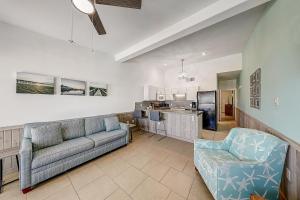 a living room with a couch and a kitchen at Ocean Waves in Port Aransas