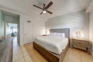 a bedroom with a bed and a ceiling fan at Ocean Waves in Port Aransas +35 photos