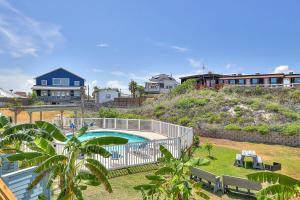 a view of a swimming pool with a house at Ocean Waves in Port Aransas