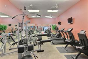 a gym with a lot of treadmills and machines at Beach Club 323 in Padre Island