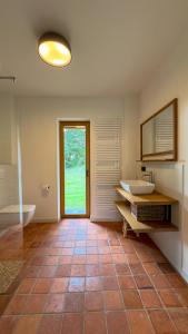 a bathroom with a tub and a sink and a window at Pausenhof Spreewald in Unterspreewald +38 photos