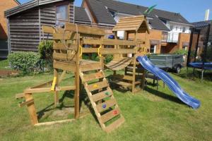 a wooden playset with a slide and a slideintend at Seaside-Amrum-5 in Norddorf +3 photos