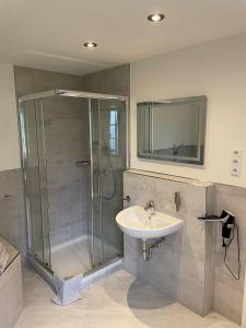 a bathroom with a shower and a sink at Seaside-Amrum-5 in Norddorf