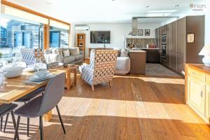 a kitchen and living room with a table and chairs at Waters Edge 16, Heron Lodge in South Cerney