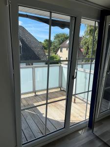 a sliding glass door with a view of a balcony at Seaside-Amrum-11 in Norddorf