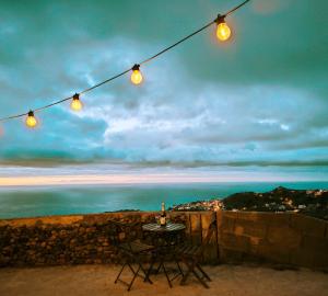 a table and chairs with lights over the ocean at Buen Paso in Icod de los Vinos +6 photos