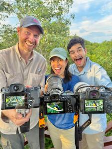 a group of three people holding up cameras at Treehouse Tulum H2Ojos in Tulum